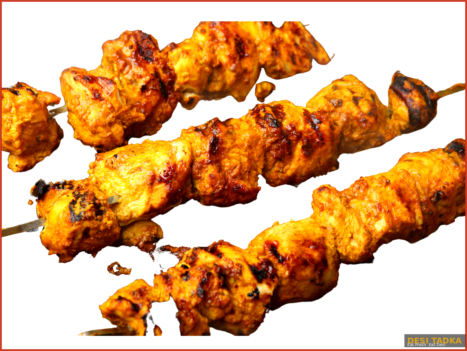 Charred chicken tikka skewers fresh off the tandoor, perfect for backyard parties.